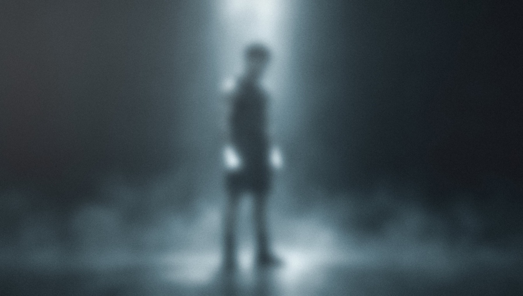 A boxer standing still in a shaft of light, head lowered, his outline soft and unresolved.
